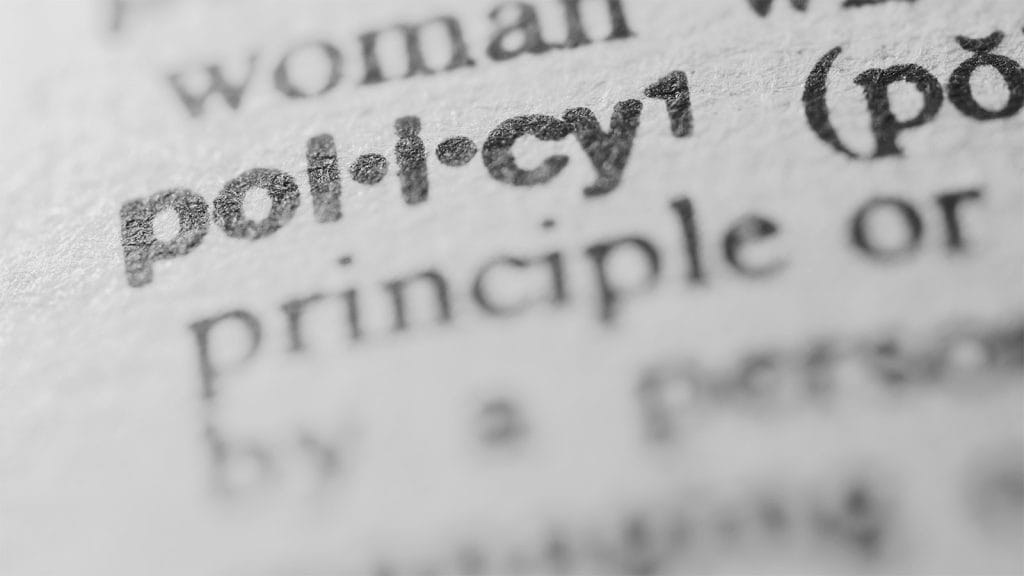Close up image of the word 'policy' in a dictionary. Privacy Policy.