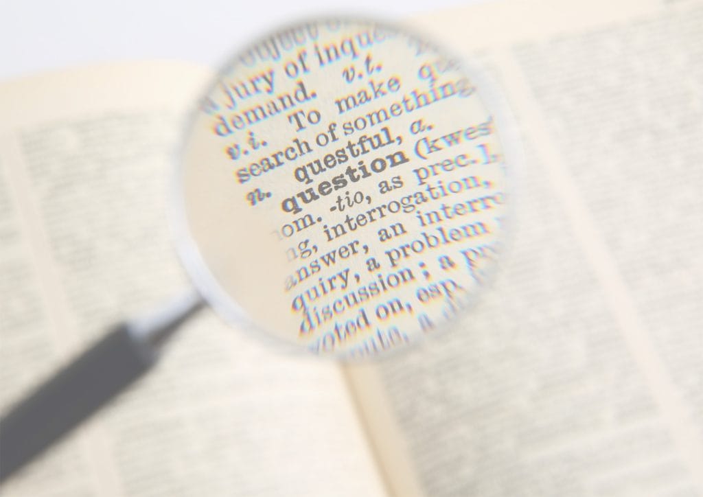 An image of a magnifying glass being held over the word 'question' in a dictionary. FAQ.